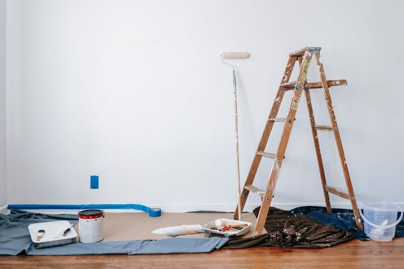 Handyman repairing a wooden porch railing in Madison