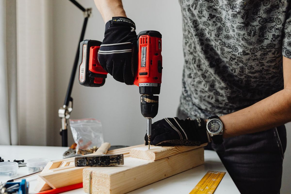 Handyman assembling furniture in a Madison room