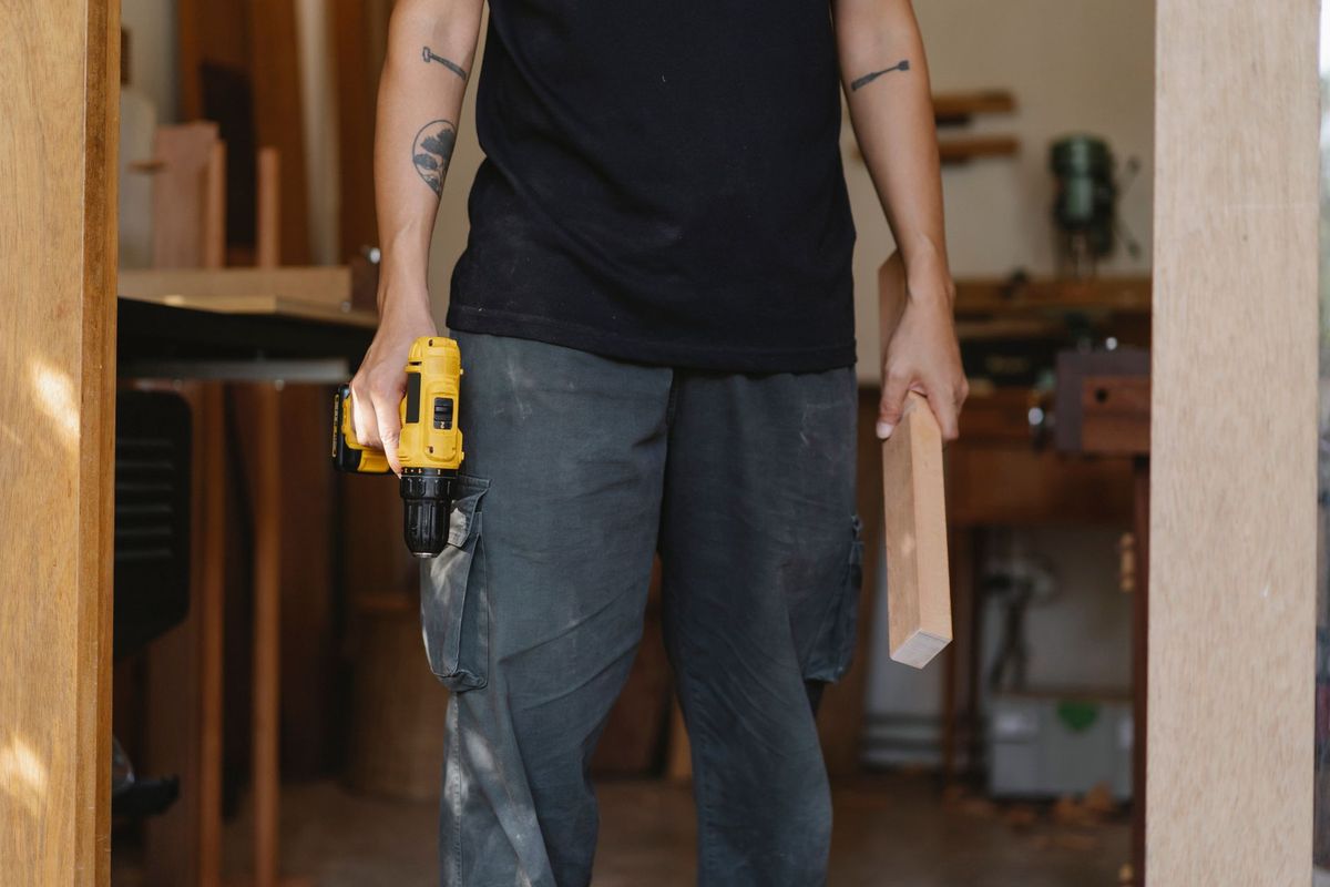 Handyman painting an interior wall in a Madison home